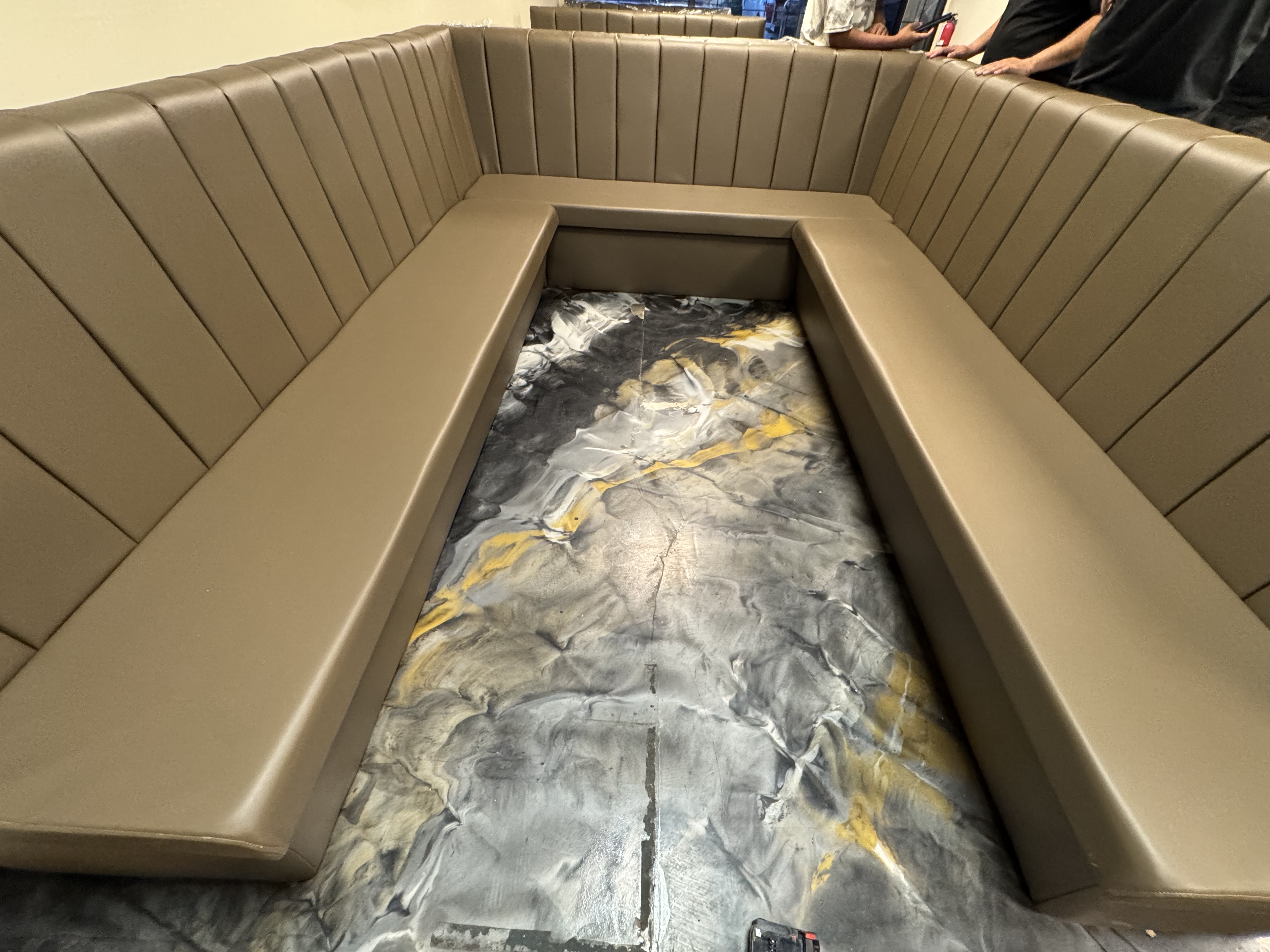 Channel-tufted restaurant booth corner in tan vinyl
