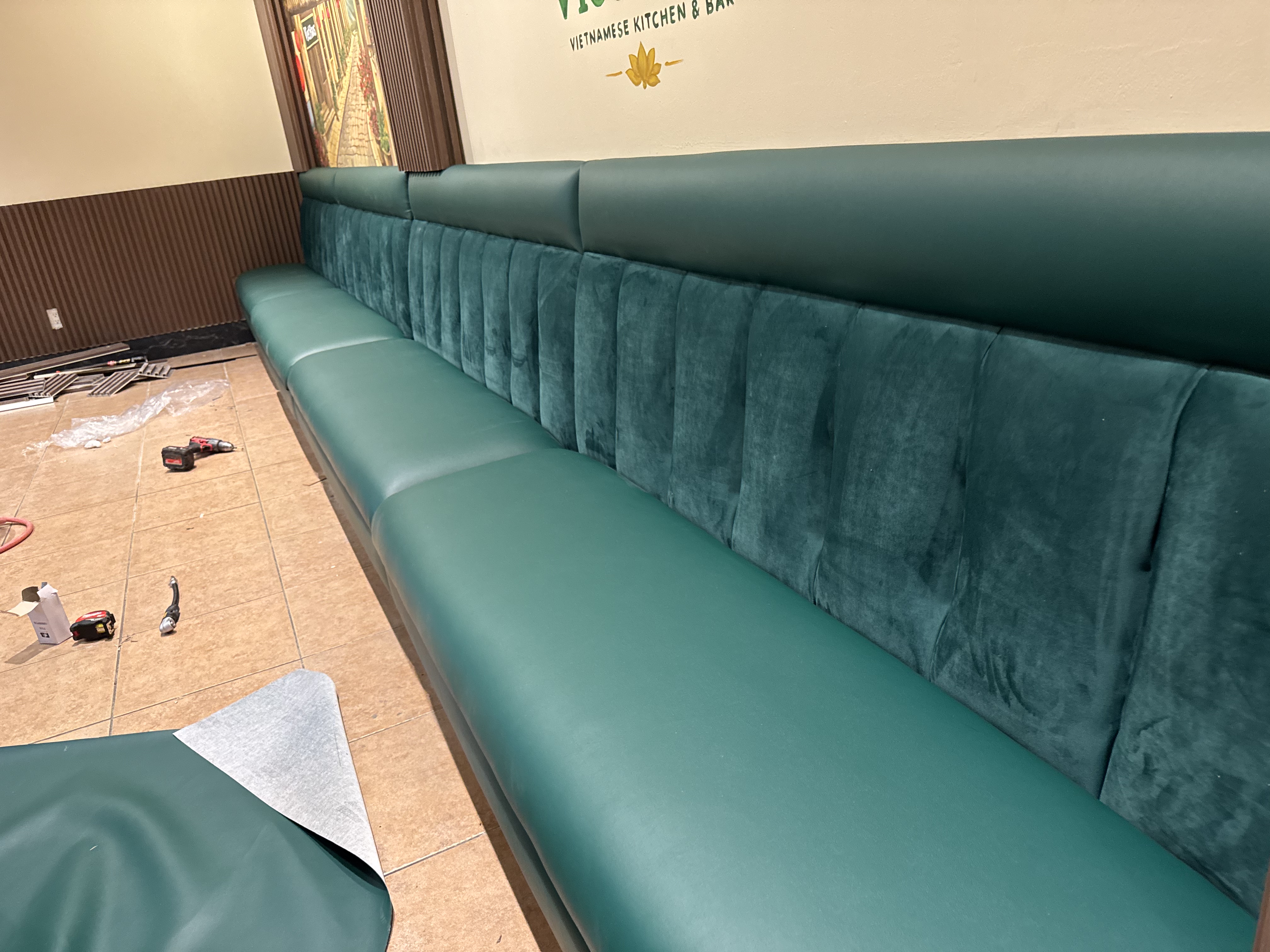 Green velvet channel-tufted restaurant banquette